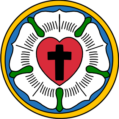 The Luther Rose, an emblem of a 5 pointed white rose with green leaves and a red heart with a black cross in the centre. The rose is in a blue disc with a gold surround.